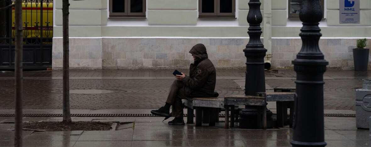 person alone in a busy city